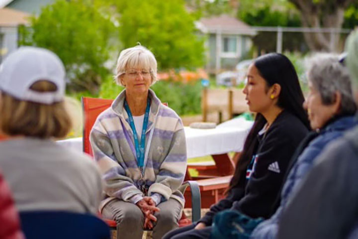 A group of people talking in a seated circle